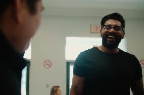 A man laughing in conversation