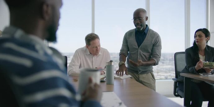 A leader at the head of a meeting table